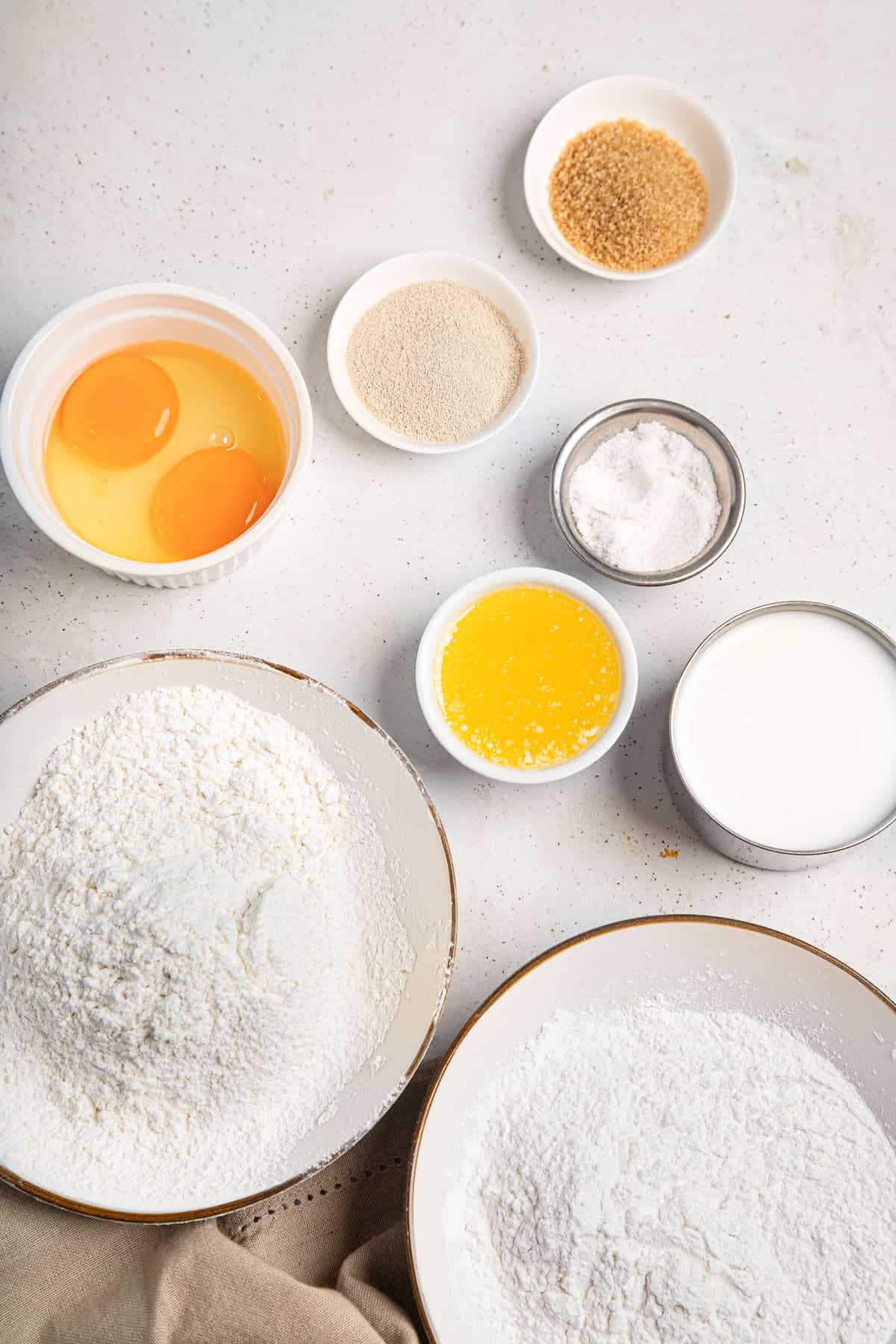 ingredients for rolls with flour, eggs, butter and yeast