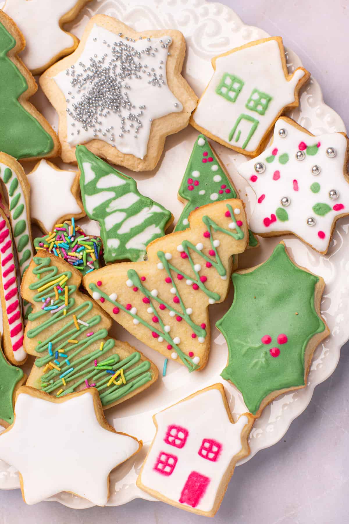 A close up on holiday cookies on a plate.