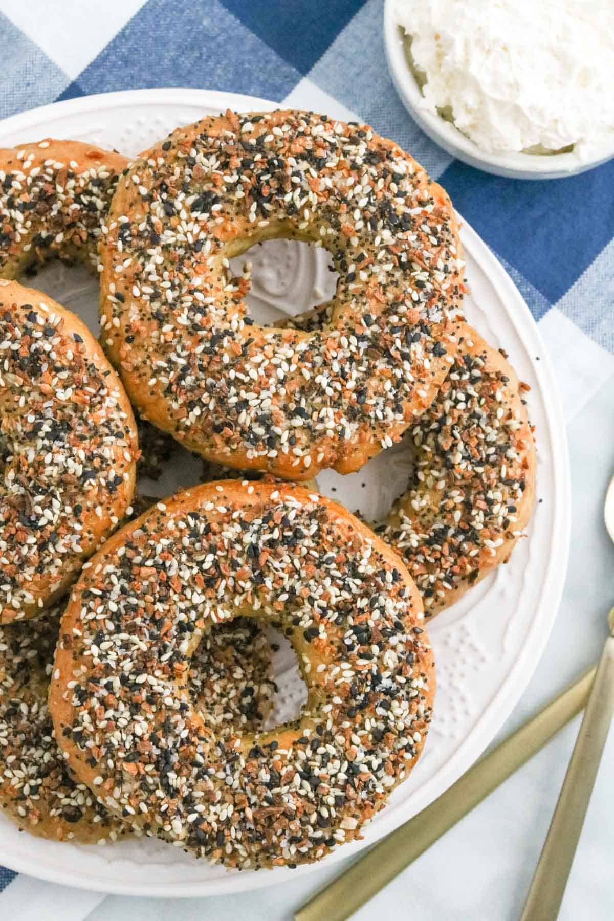 Gluten free Everything bagels stacked on a plate.