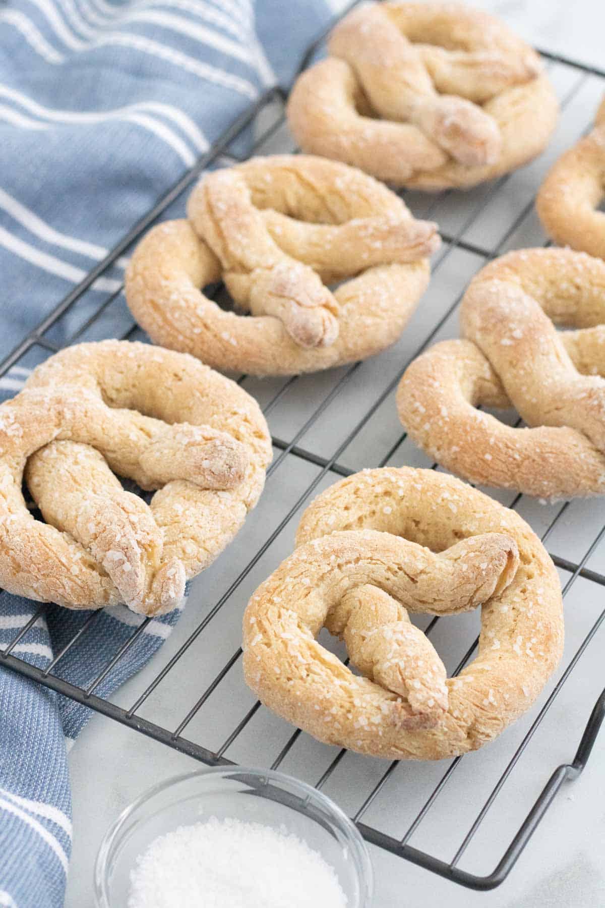 Baked soft pretzels on a wire rack.
