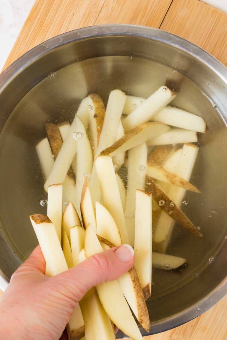 putting the raw fries i a bowl of water
