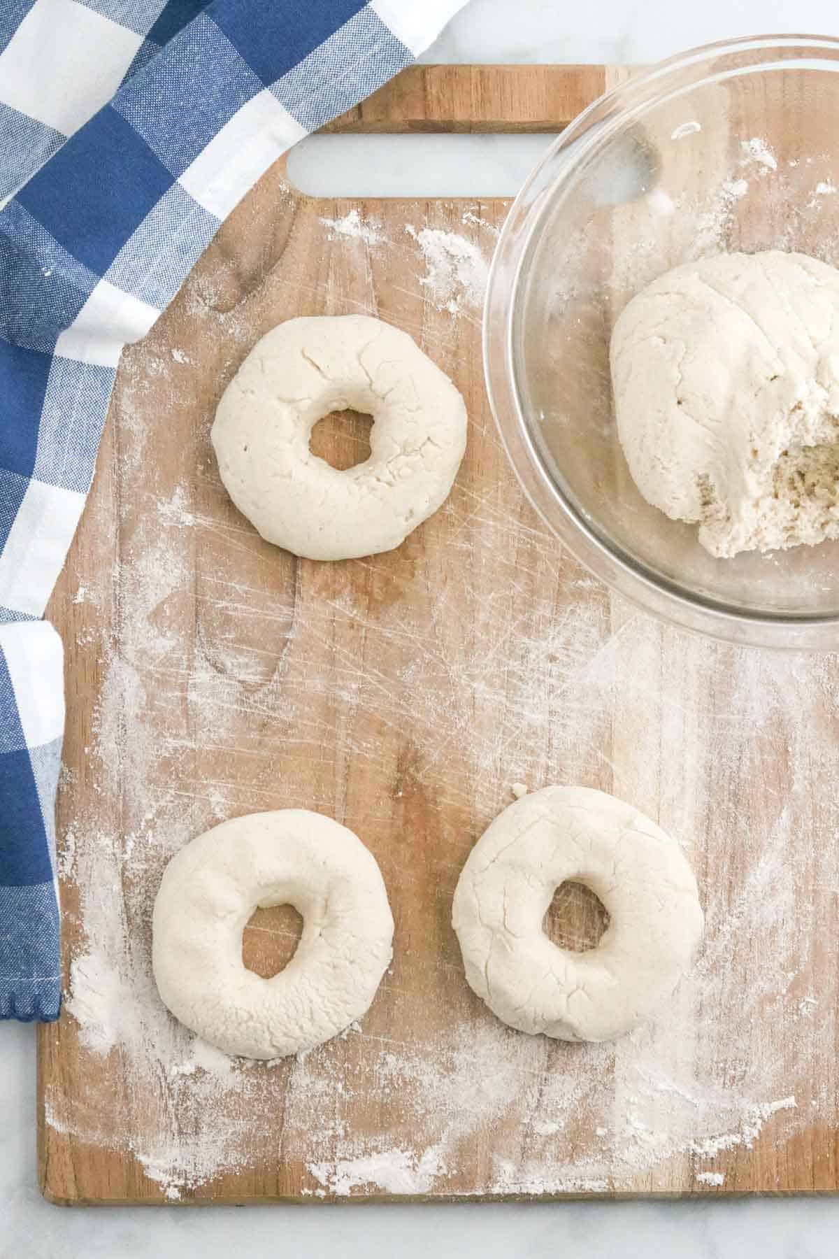 Bagel dough is rolled and shaped into bagels.