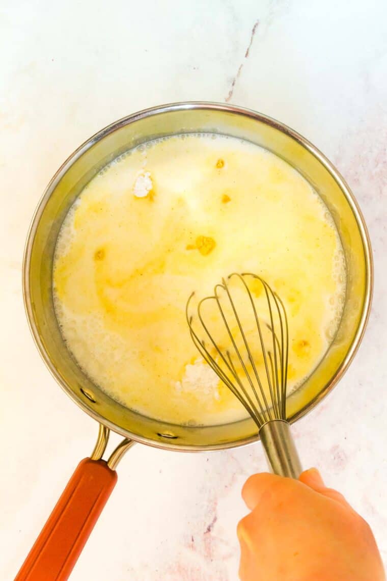 A whisk is used to combine the dry mustard and cornstarch into the milk for mac and cheese sauce.