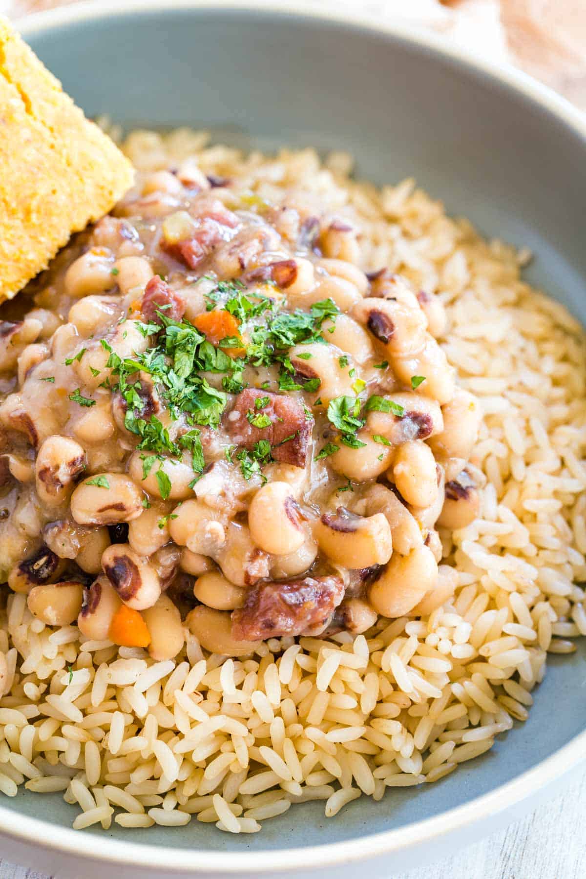 Black eyed peas served over rice, with a side of corn bread.