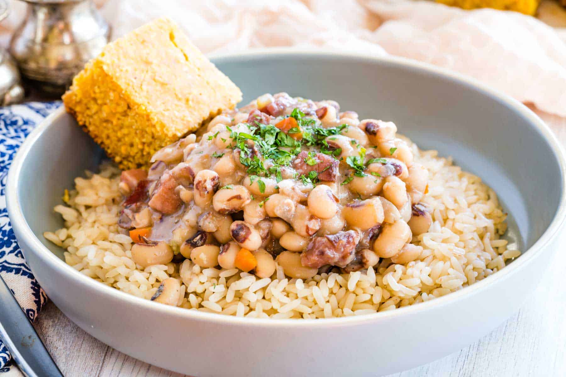 Black eyed peas served over rice, with a side of corn bread.