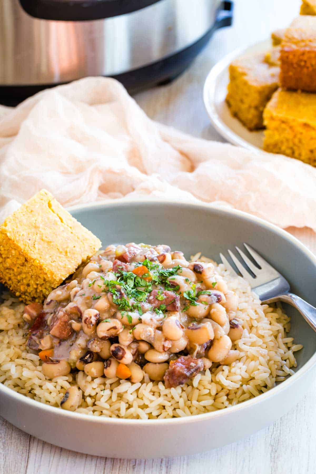 Black eyed peas served over rice, with a side of corn bread.