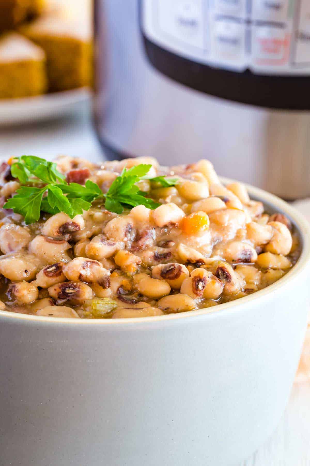 A bowl of black eyed peas topped with fresh parsley.