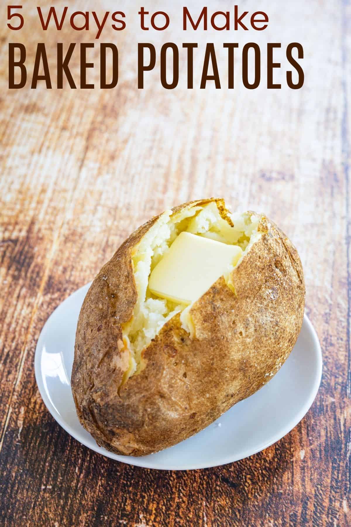 baked potato on a plate cut open with a pat of butter inside