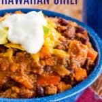 a bowl of hawaiian chili with pineapple and beef topped with cheese and sour cream