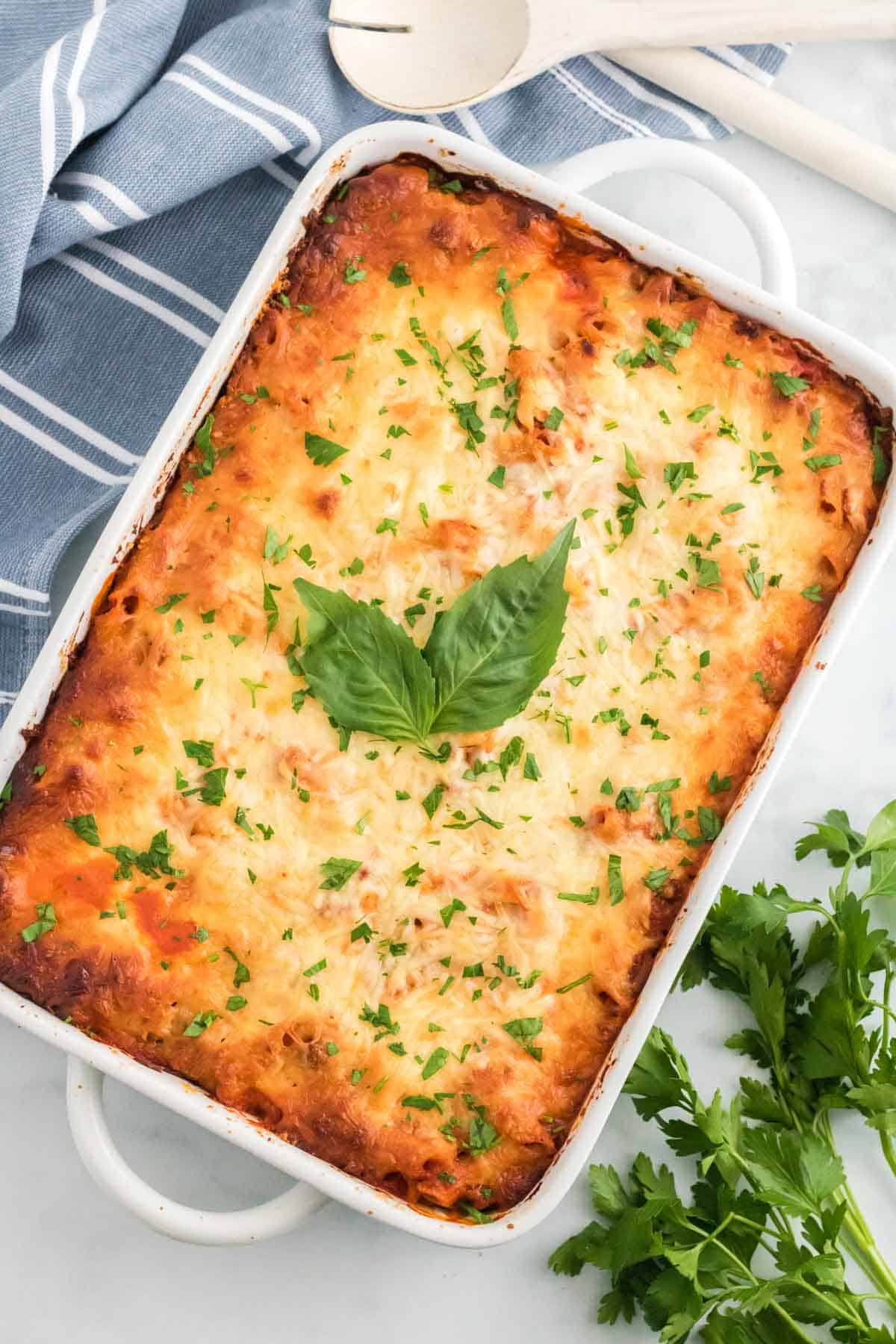 Top view of a whole baked ziti in a casserole dish.