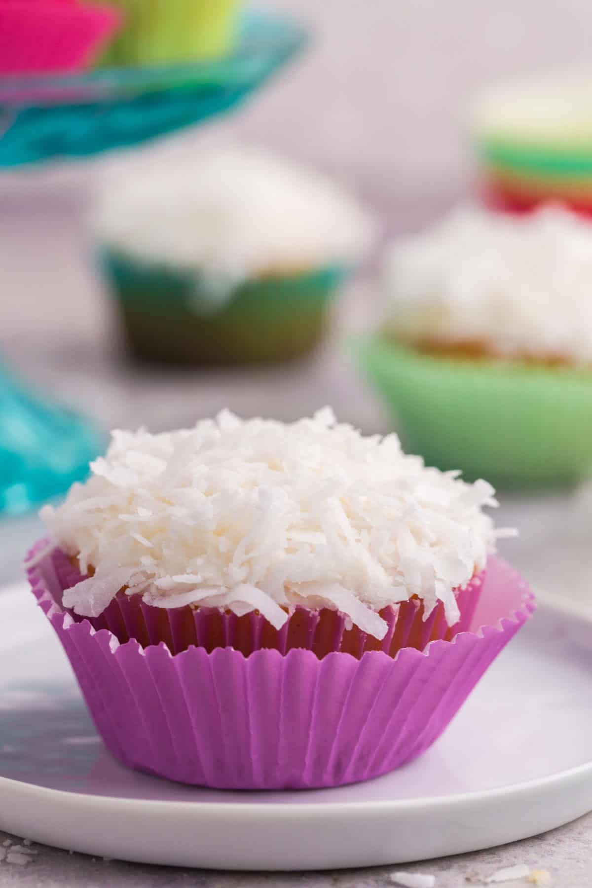 A coconut cupcake in a pink wrapper.