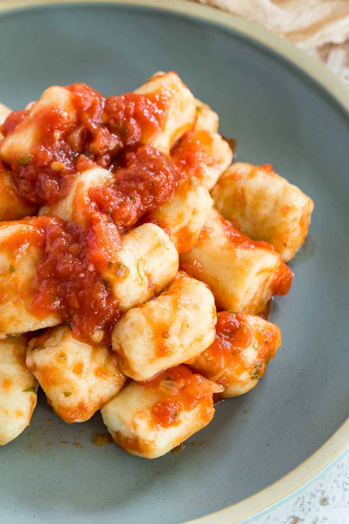 Gnocchi in tomato sauce on a plate.