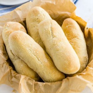 soft breadsticks in a bowl lined with parchment paper.