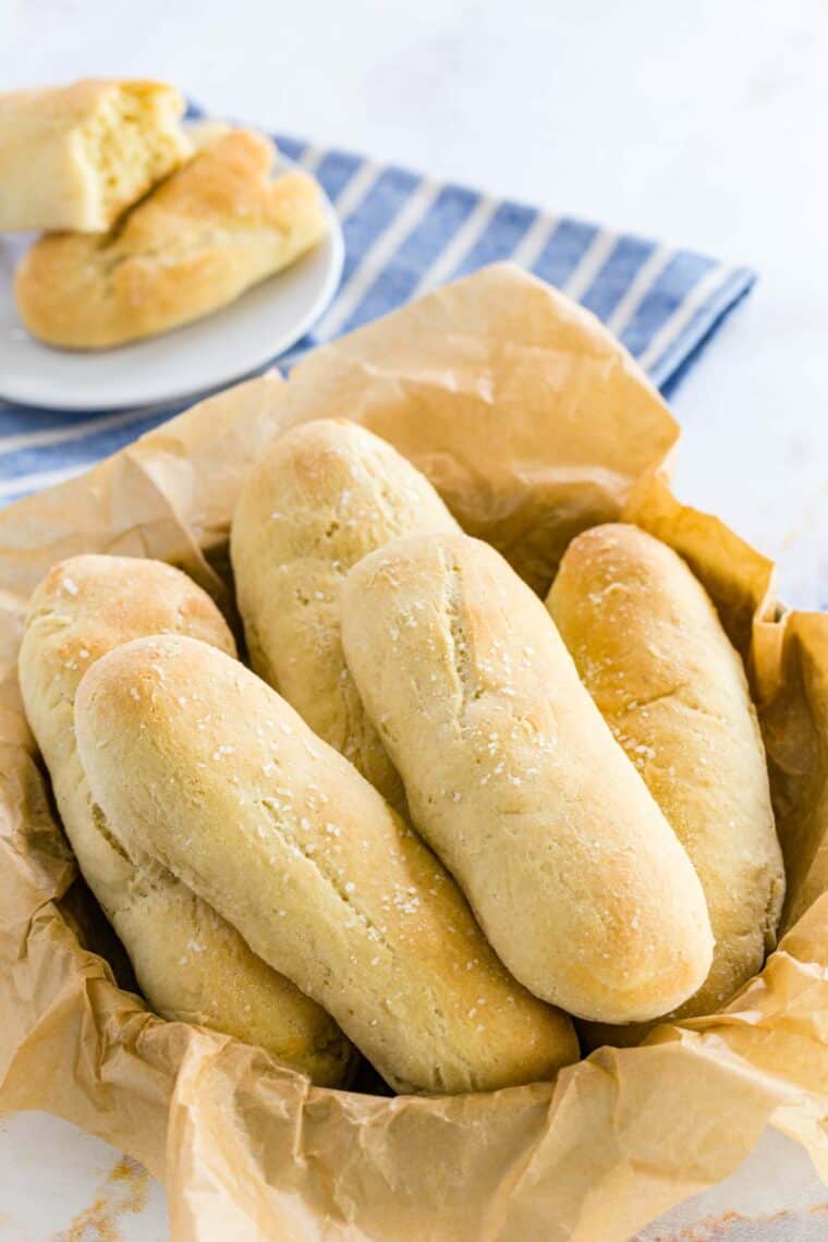 A bread basket filled with golden baked, gluten free breadsticks.