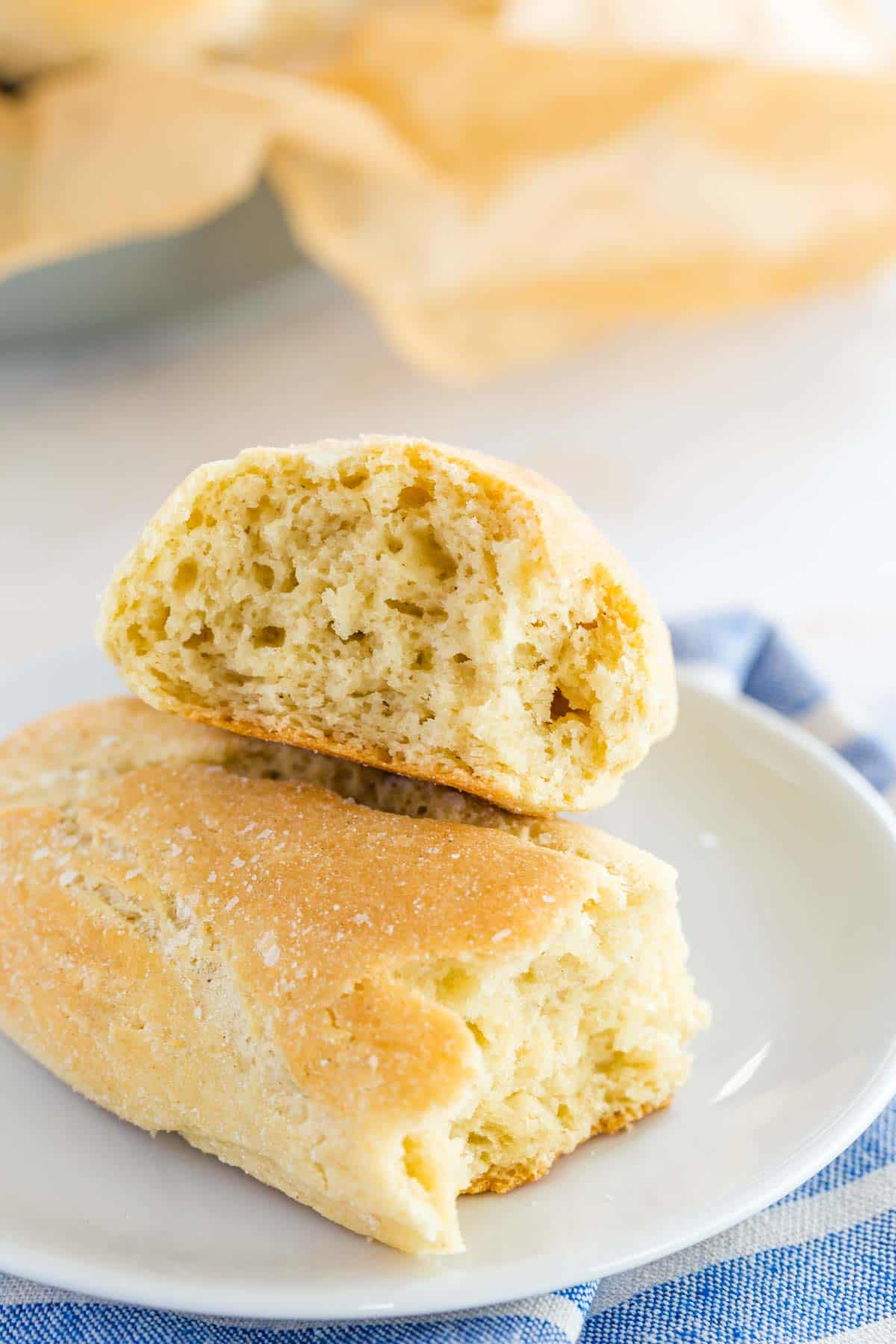 A breadstick broken open to reveal fluffy, airy insides.