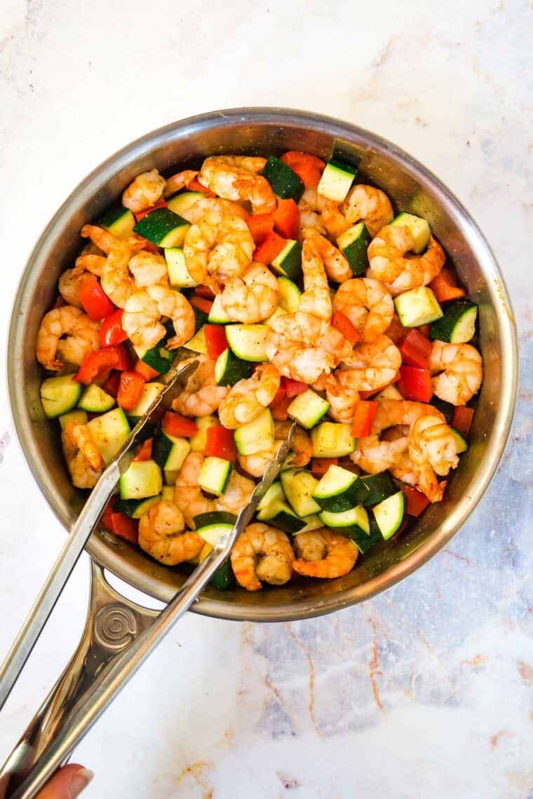 sauteeing vegetables with shrimp in a skillet