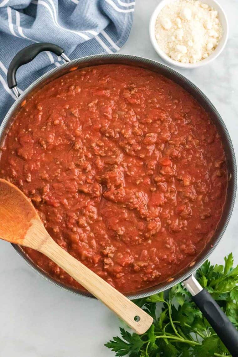 Ground beef and marinara sauce combined in a skillet for the meat sauce.