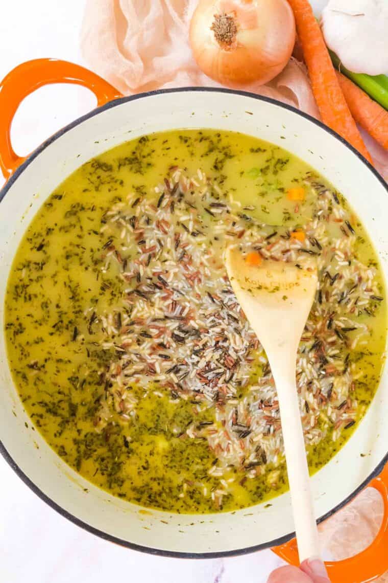Wild rice added to a pot of soup.