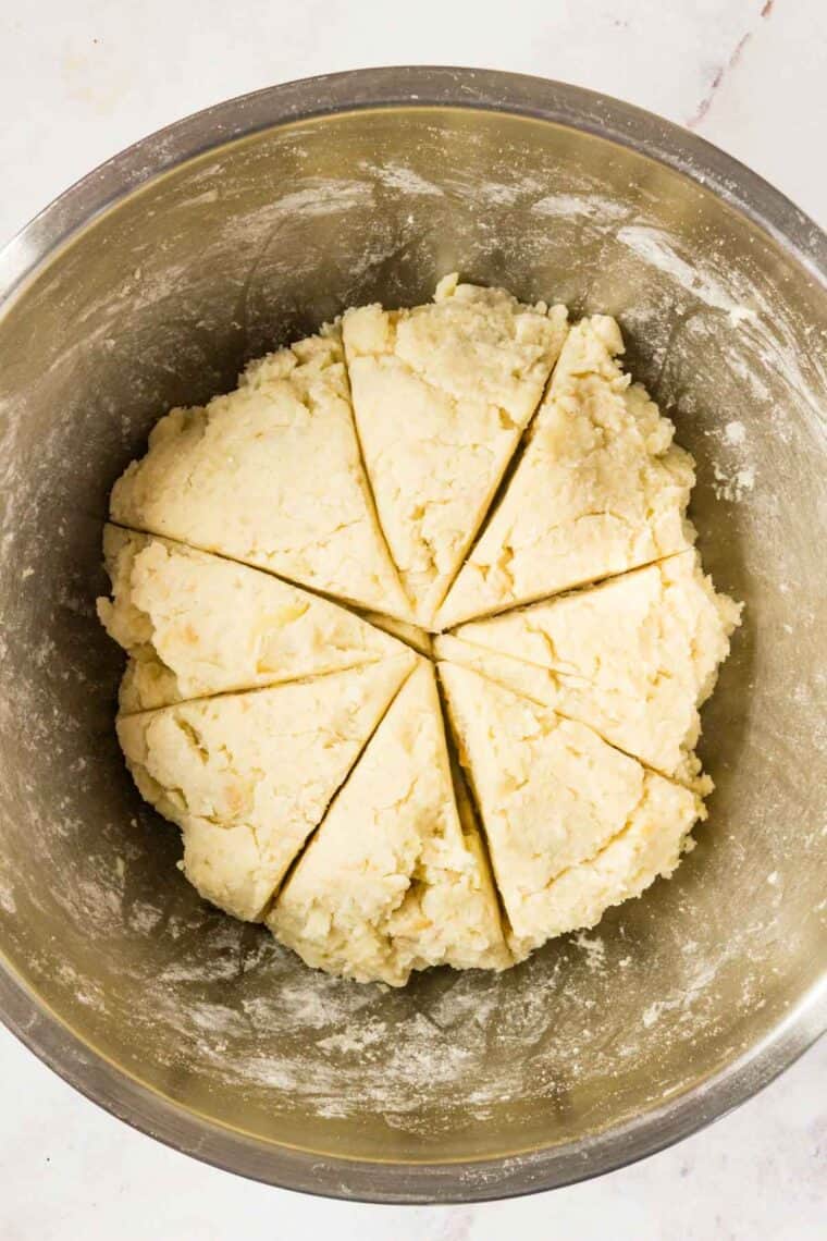 Gluten-free gnocchi dough is divided into equal parts.