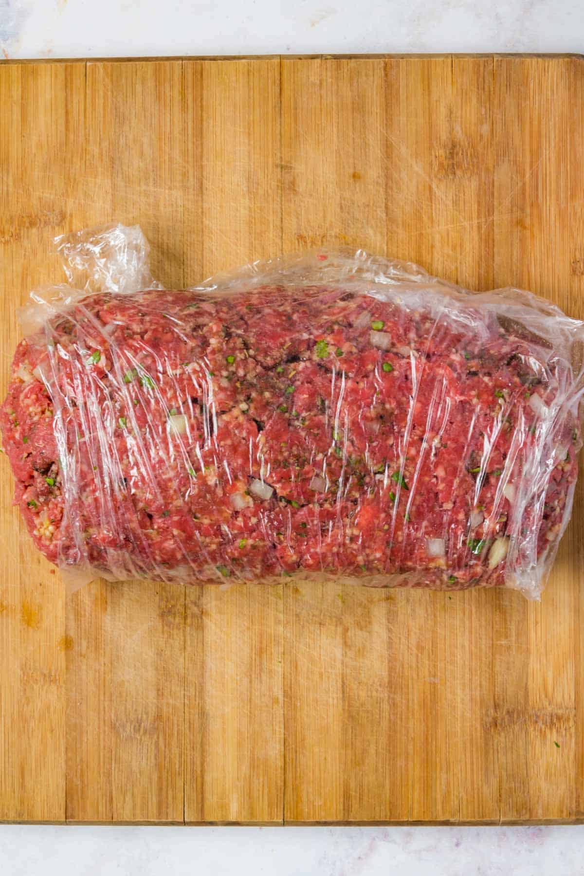 The fully rolled-up meatloaf mixture stuffed with mozzarella, parmesan and ricotta cheese