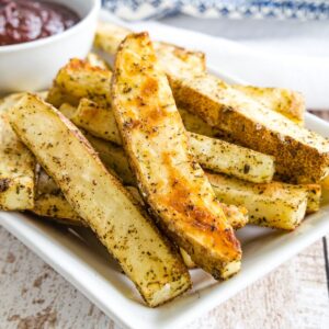 crispy herb french fries on a platter