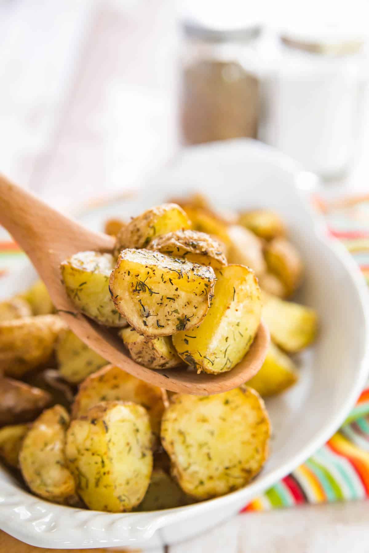 A serving spoon scoops up ranch potatoes.