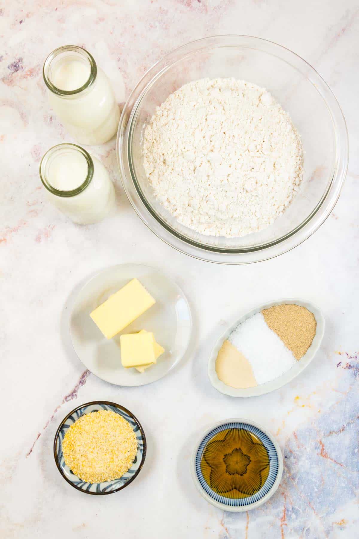 All of the ingredients to make fgluten free English muffins set out on a countertop.