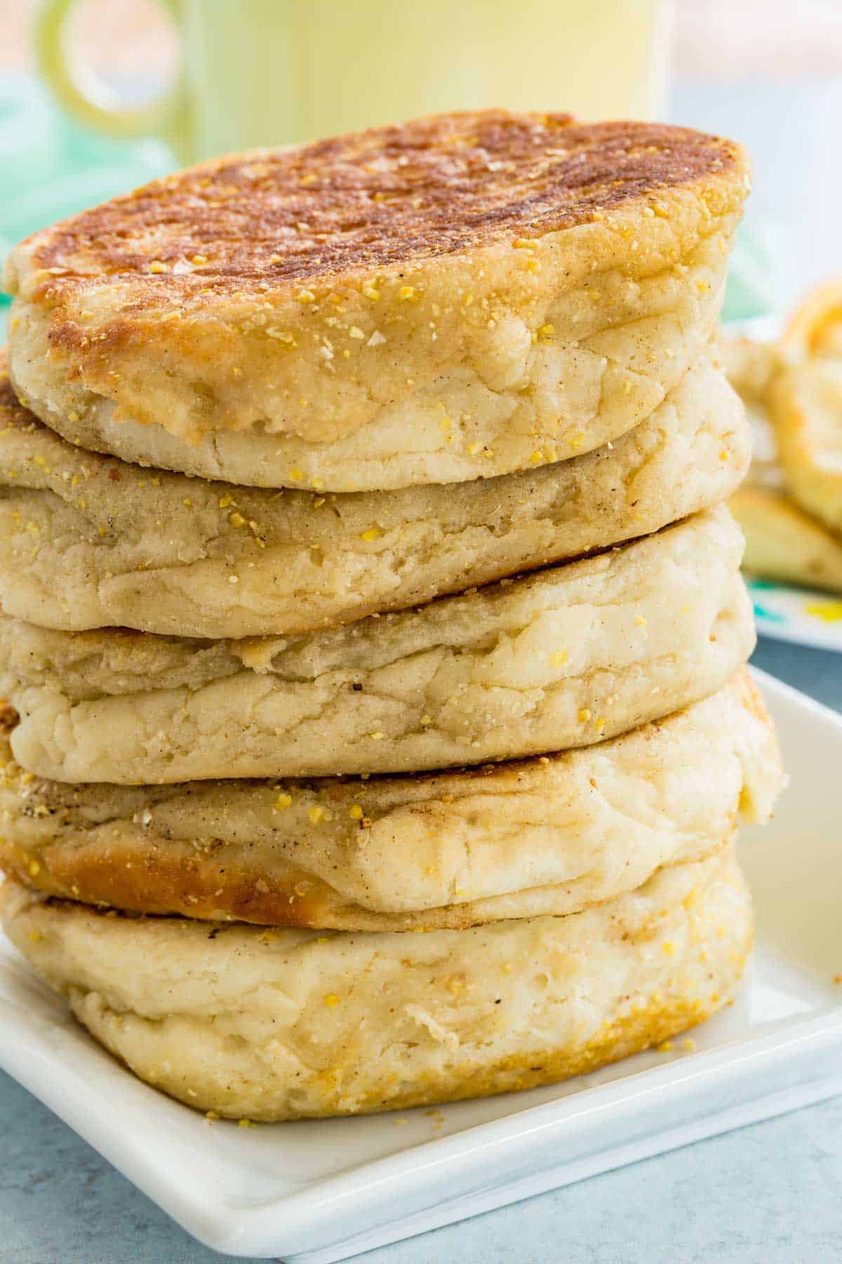 A stack of homemade gluten free English muffins.