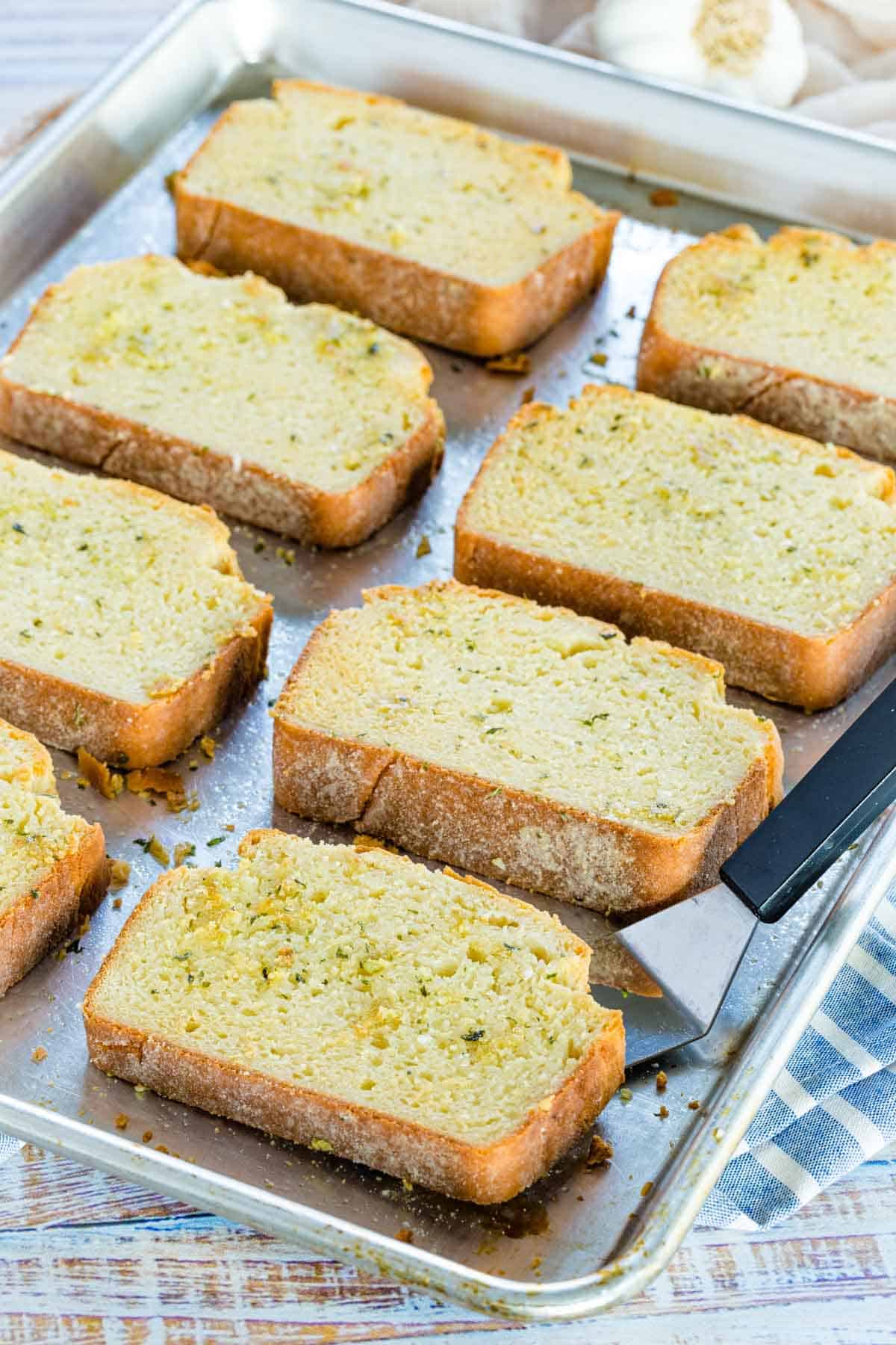 Rows of Texas garlic toast on a baking sheet.