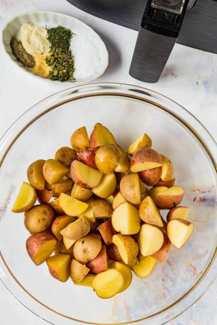 A bowl of halved baby potatoes.