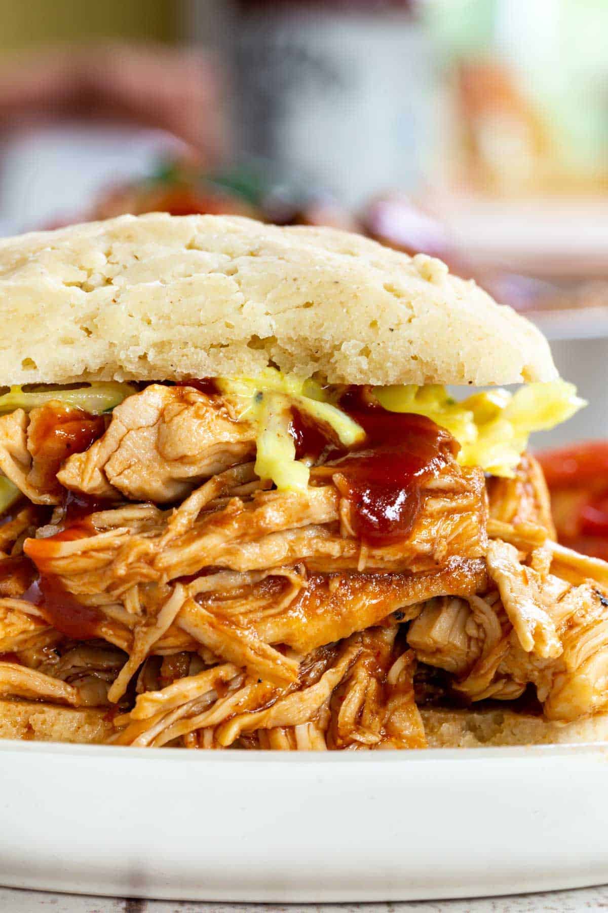 Side view of a BBQ pulled chicken sandwich.