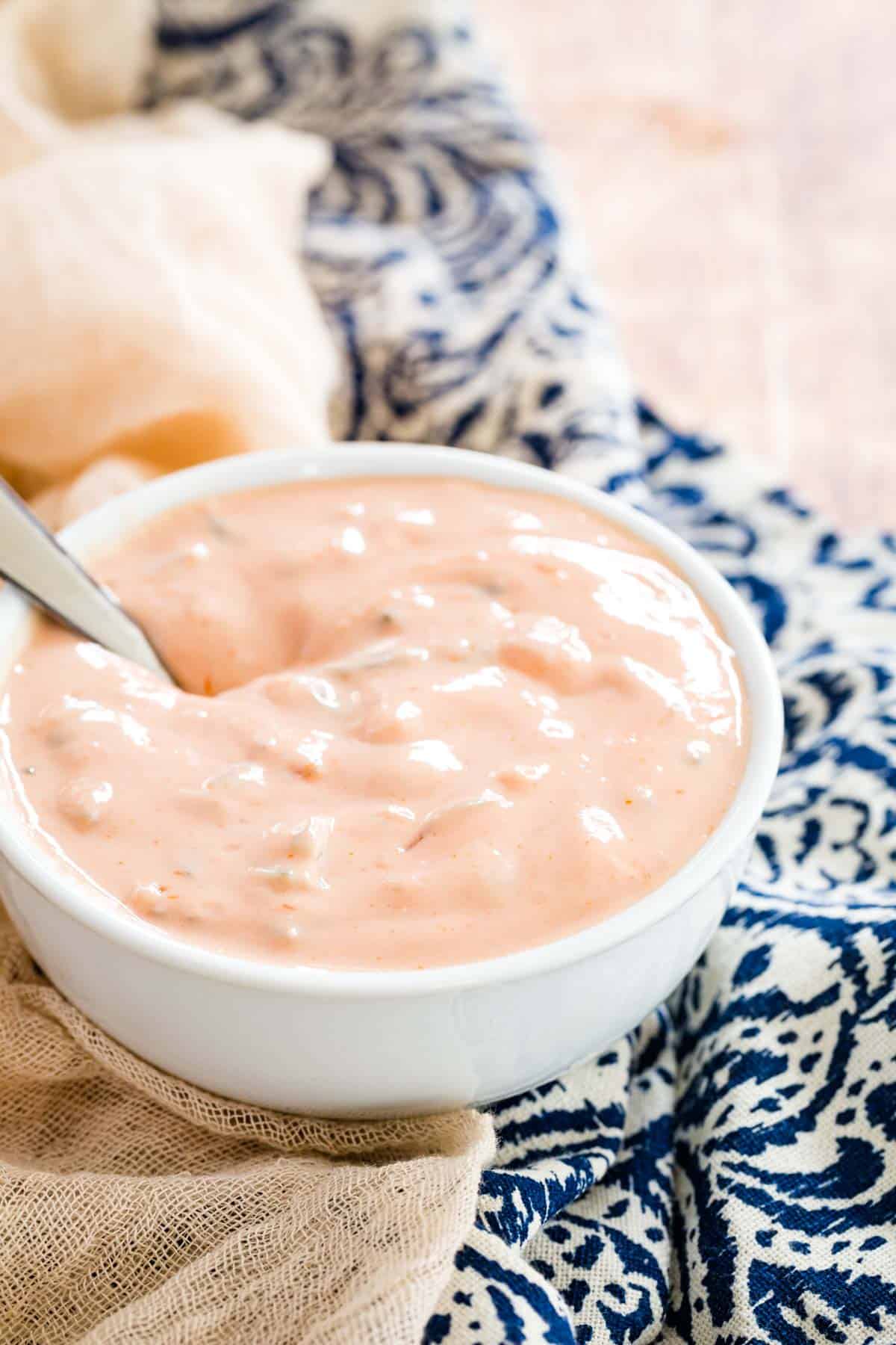 A bowl of Healthy Big Mac Sauce on a patterned tablecloth.