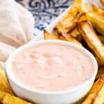 A bowl of healthy Big Mac Sauce on a rectangular plate with French fries.