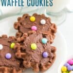 Three chocolate waffle cookies on a white plate.