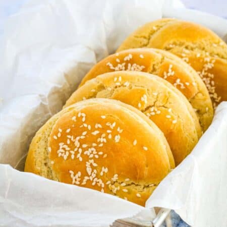 Gluten free hamburger buns in a tray.