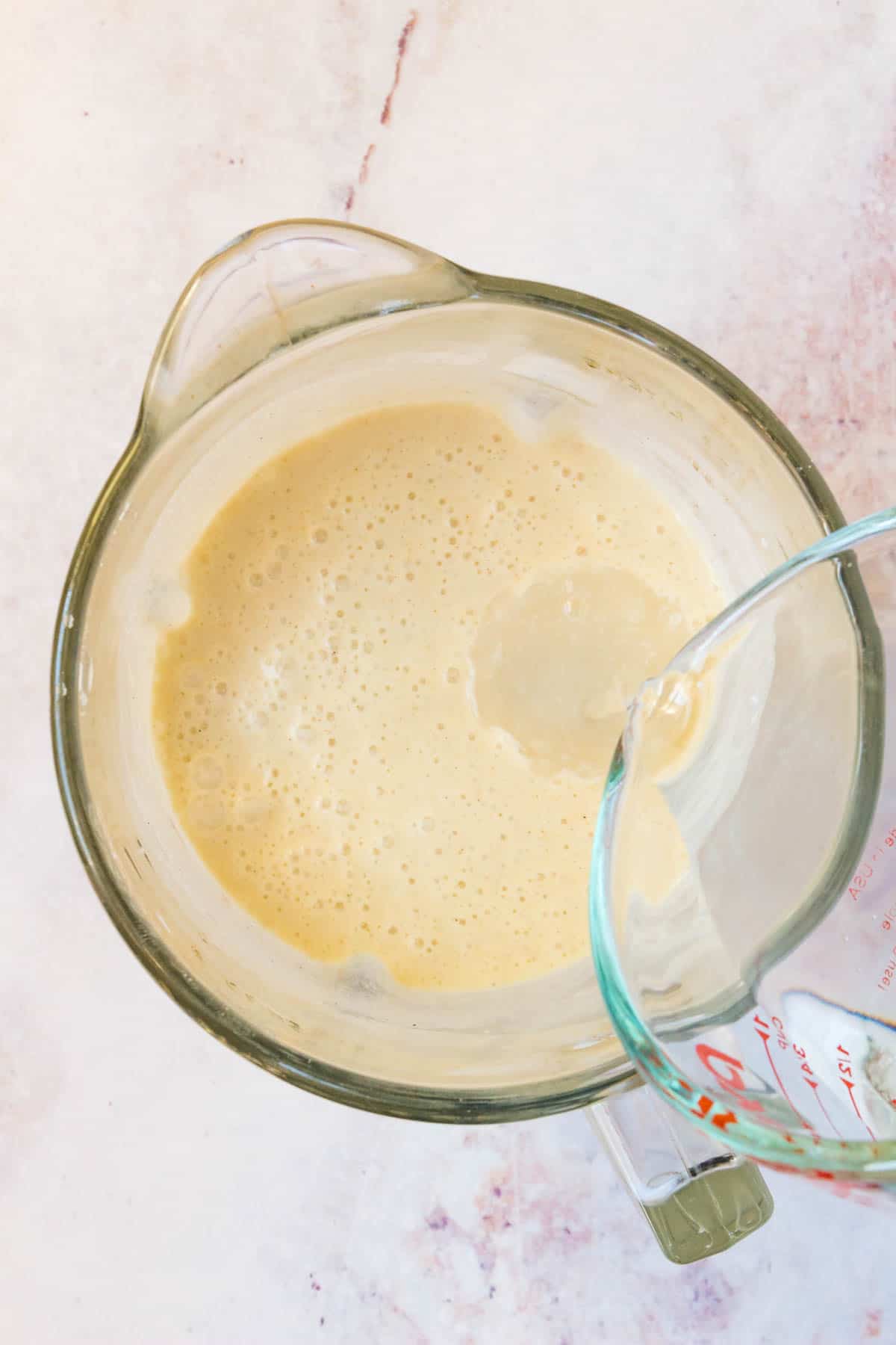 Water is added into the blender with crepe batter.