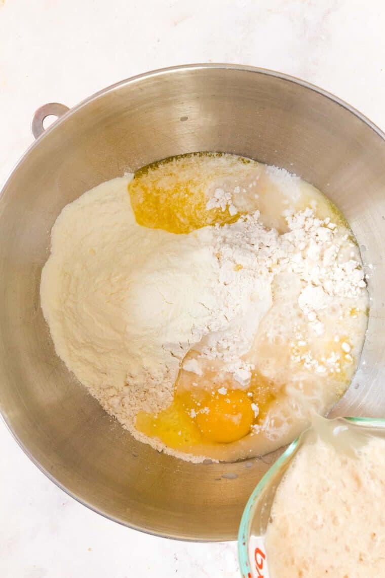 The ingredients for hamburger bun dough are combined in a mixing bowl.
