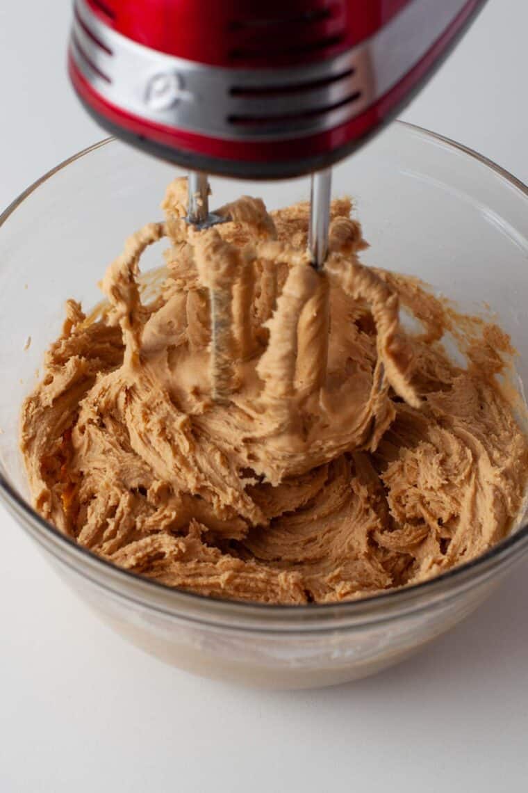 Mixing peanut butter filling with a hand mixer.