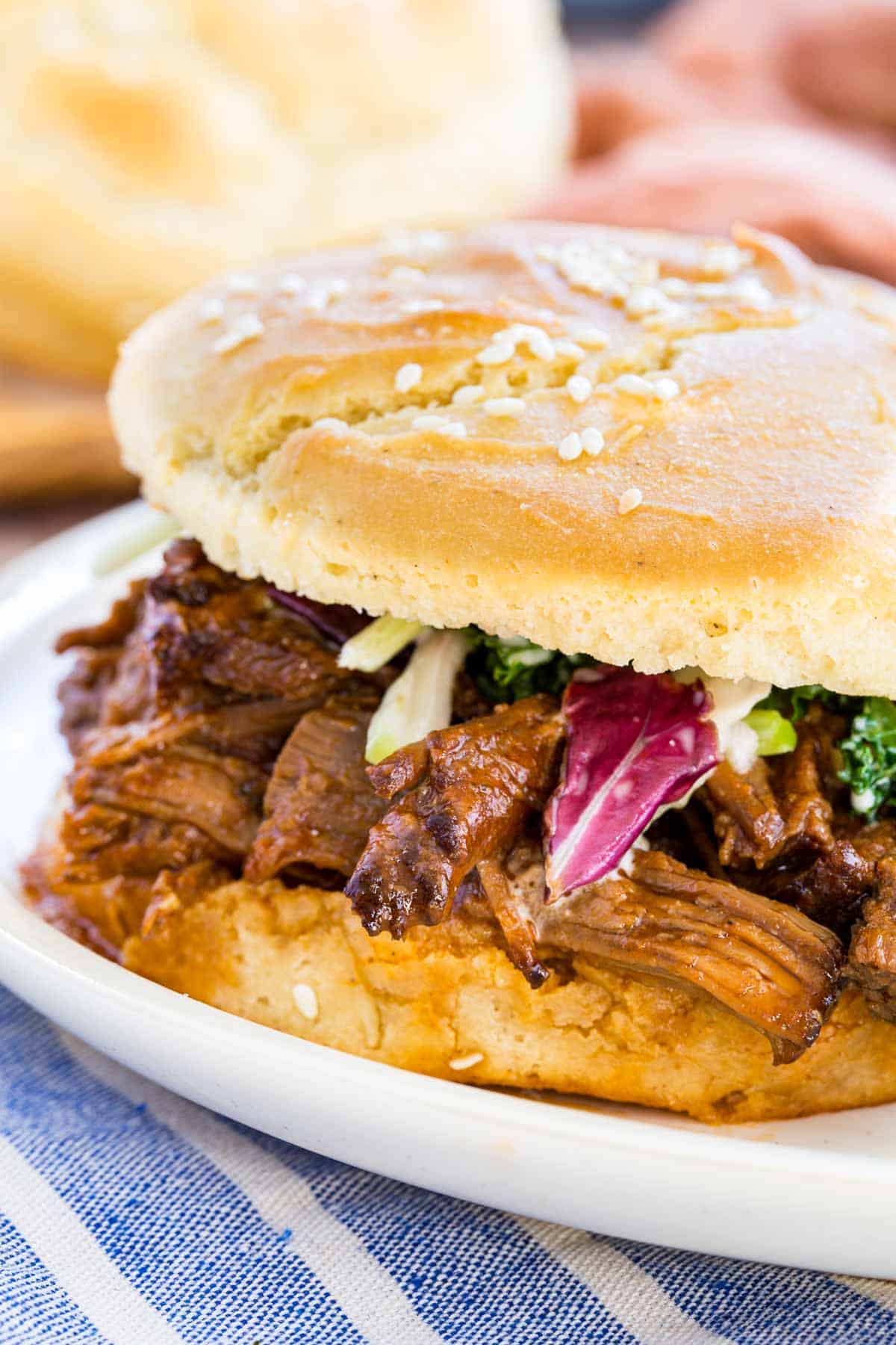 A Crockpot barbecue beef sandwich served on a plate.