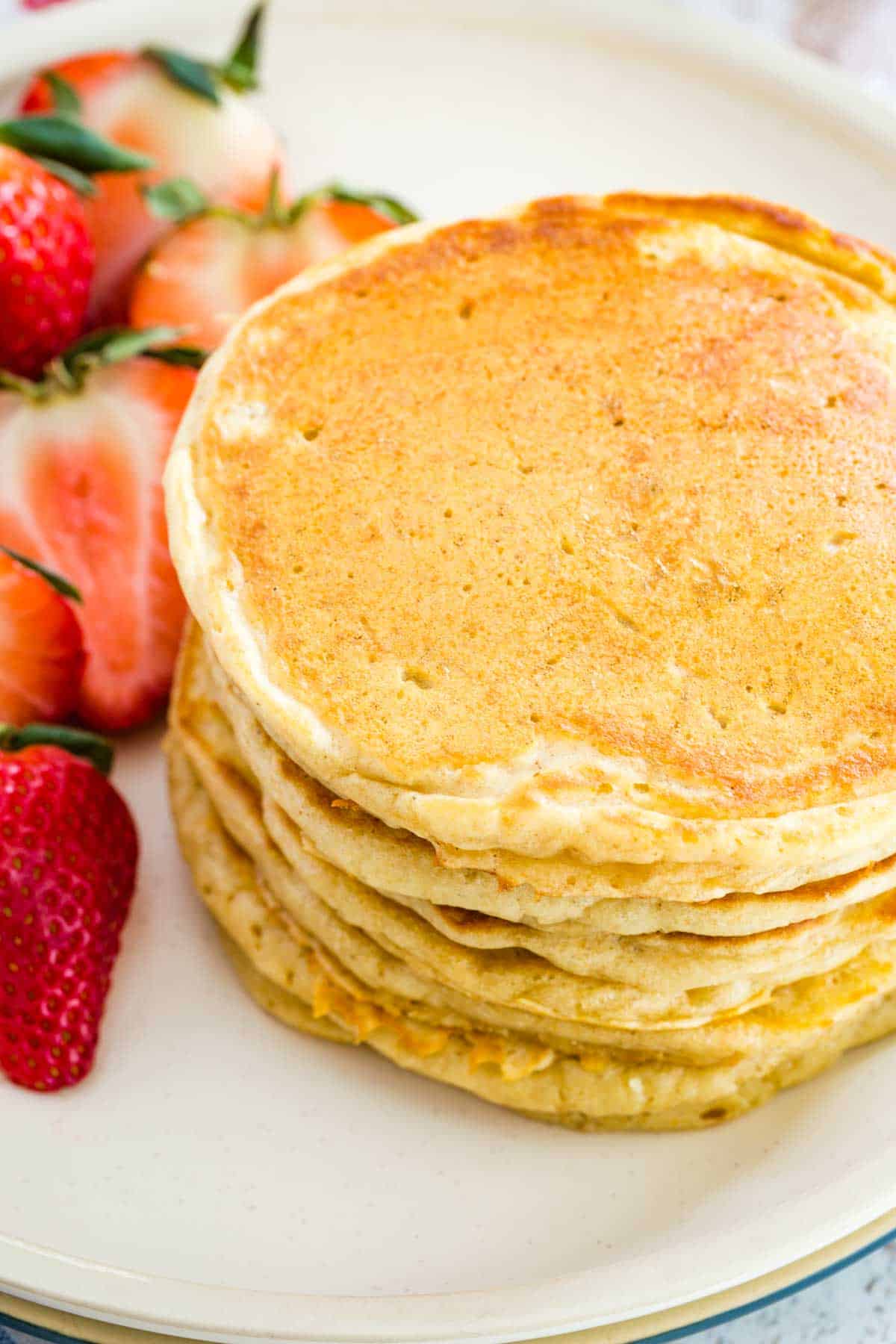 Top view of a stack of gluten free buttermilk pancakes on a plate.