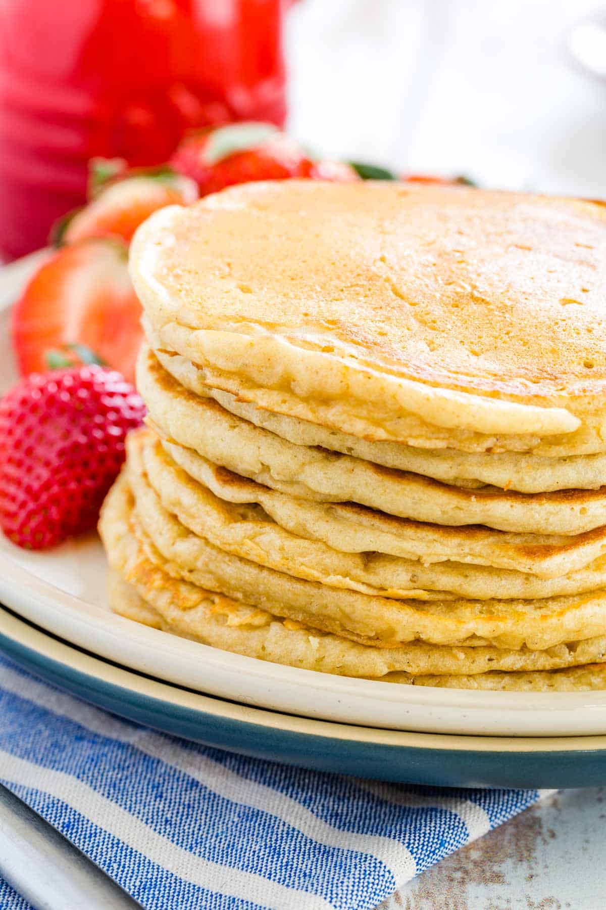 A stack of gluten free buttermilk pancakes on a plate.