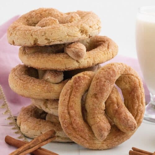 Stacked up cinnamon sugar pretzels with one leaning against the stack.