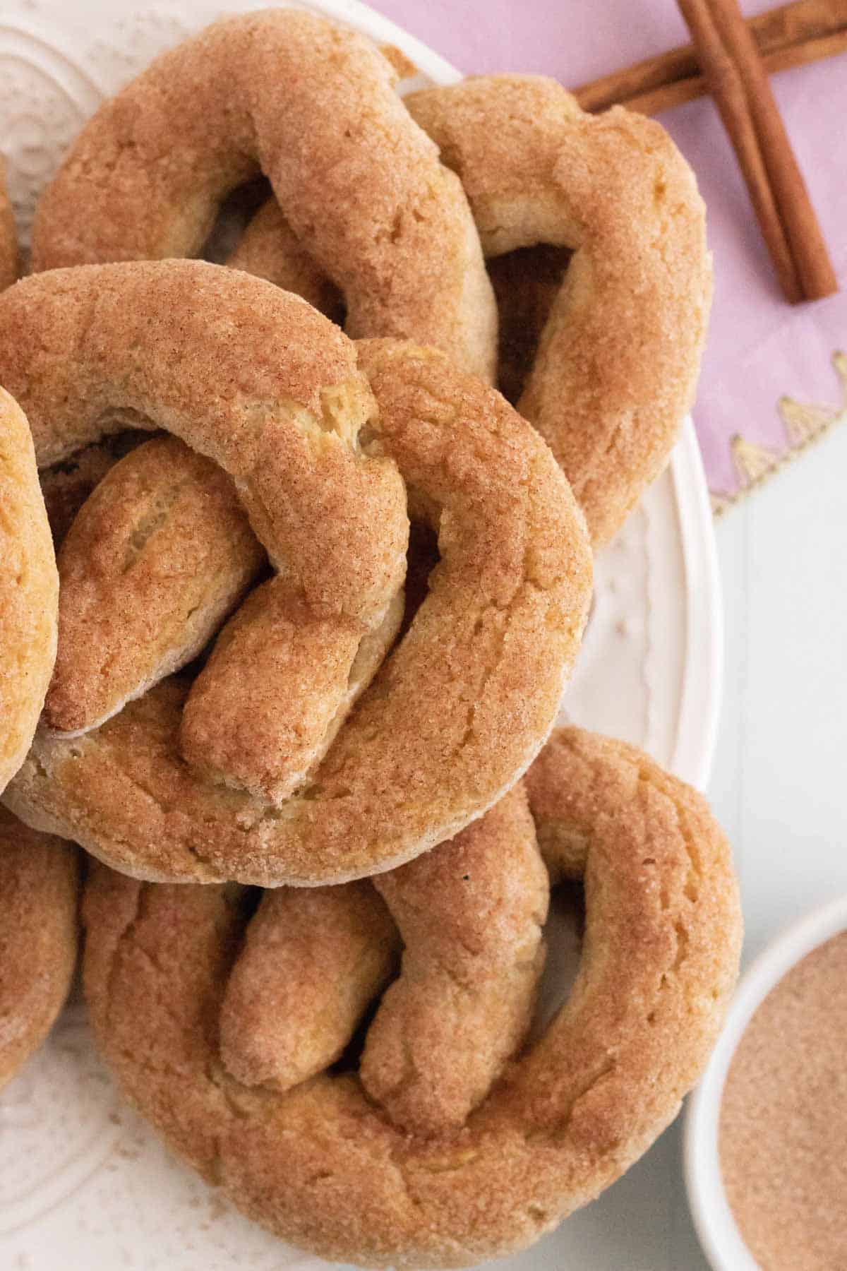 Closeup of gluten free cinnamon sugar pretzels piled on a plate.