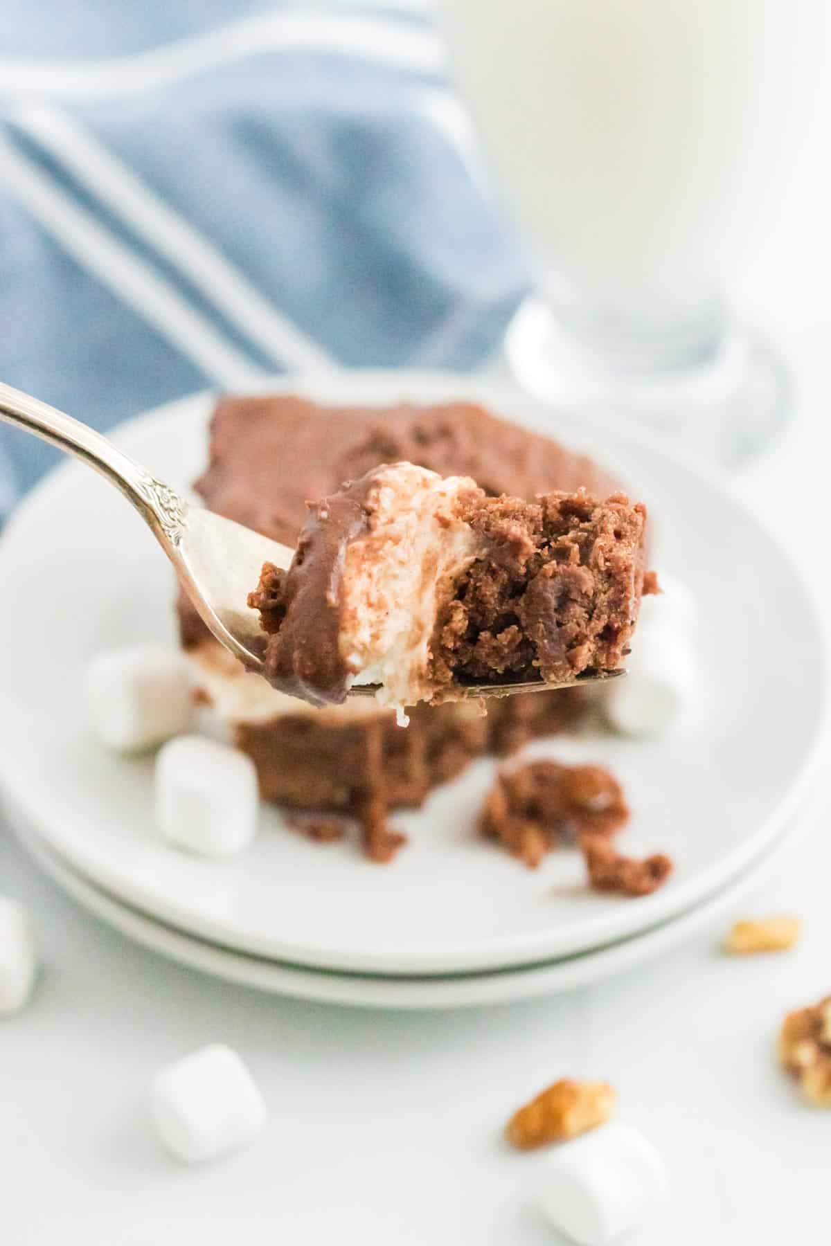A bite of rocky road brownie on a fork.