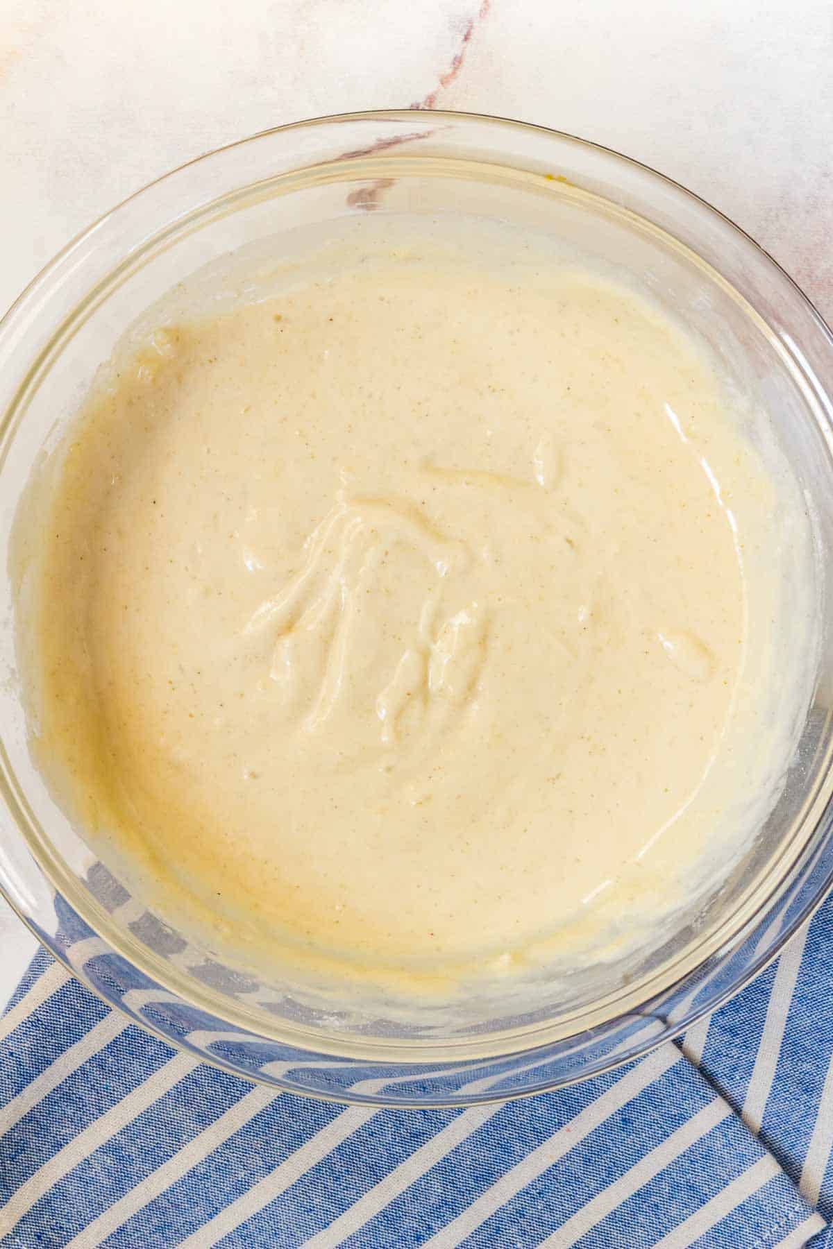 Pancake batter in a glass mixing bowl.