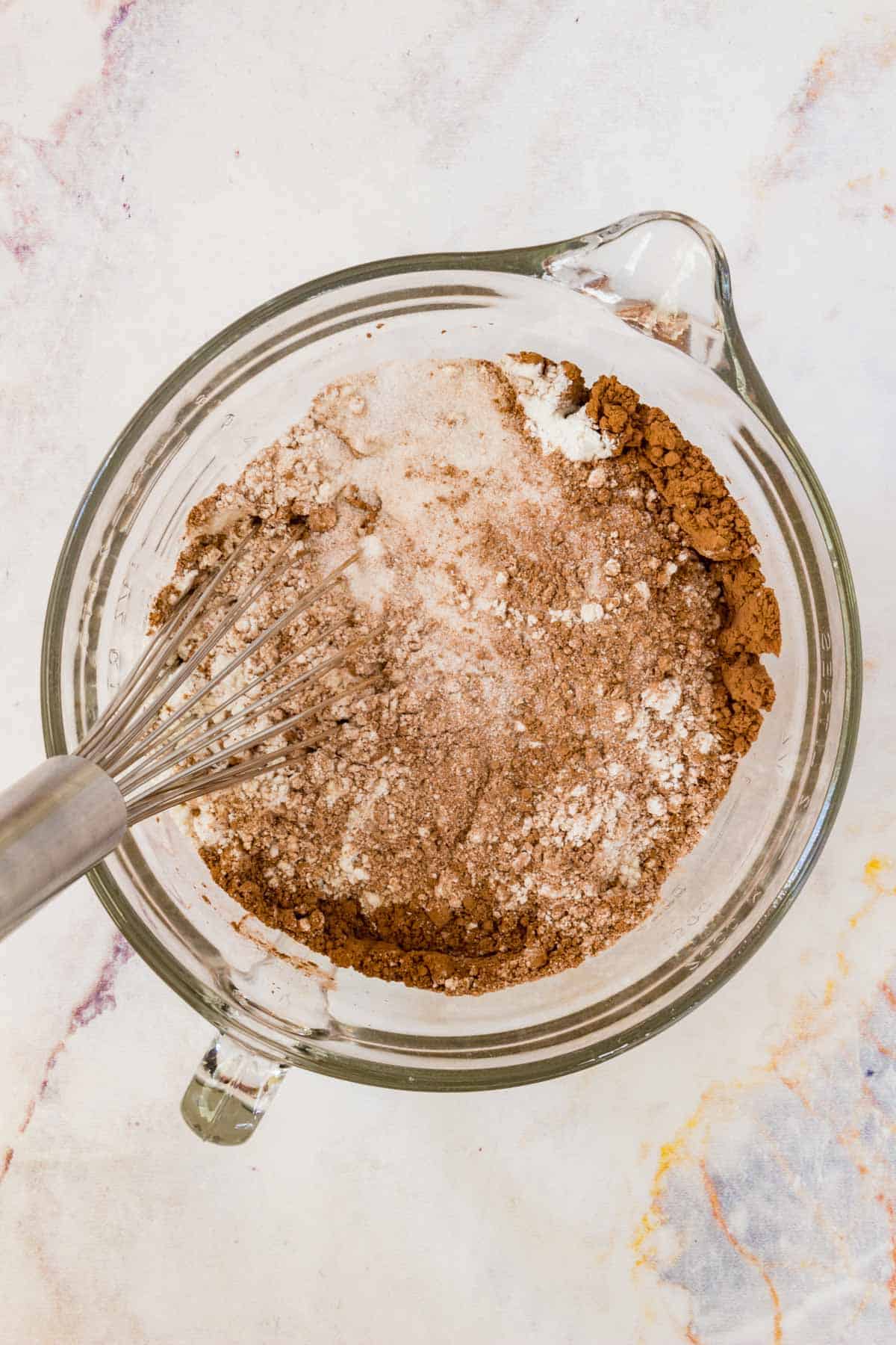 The cake ingredients are combined in a glass mixing bowl.