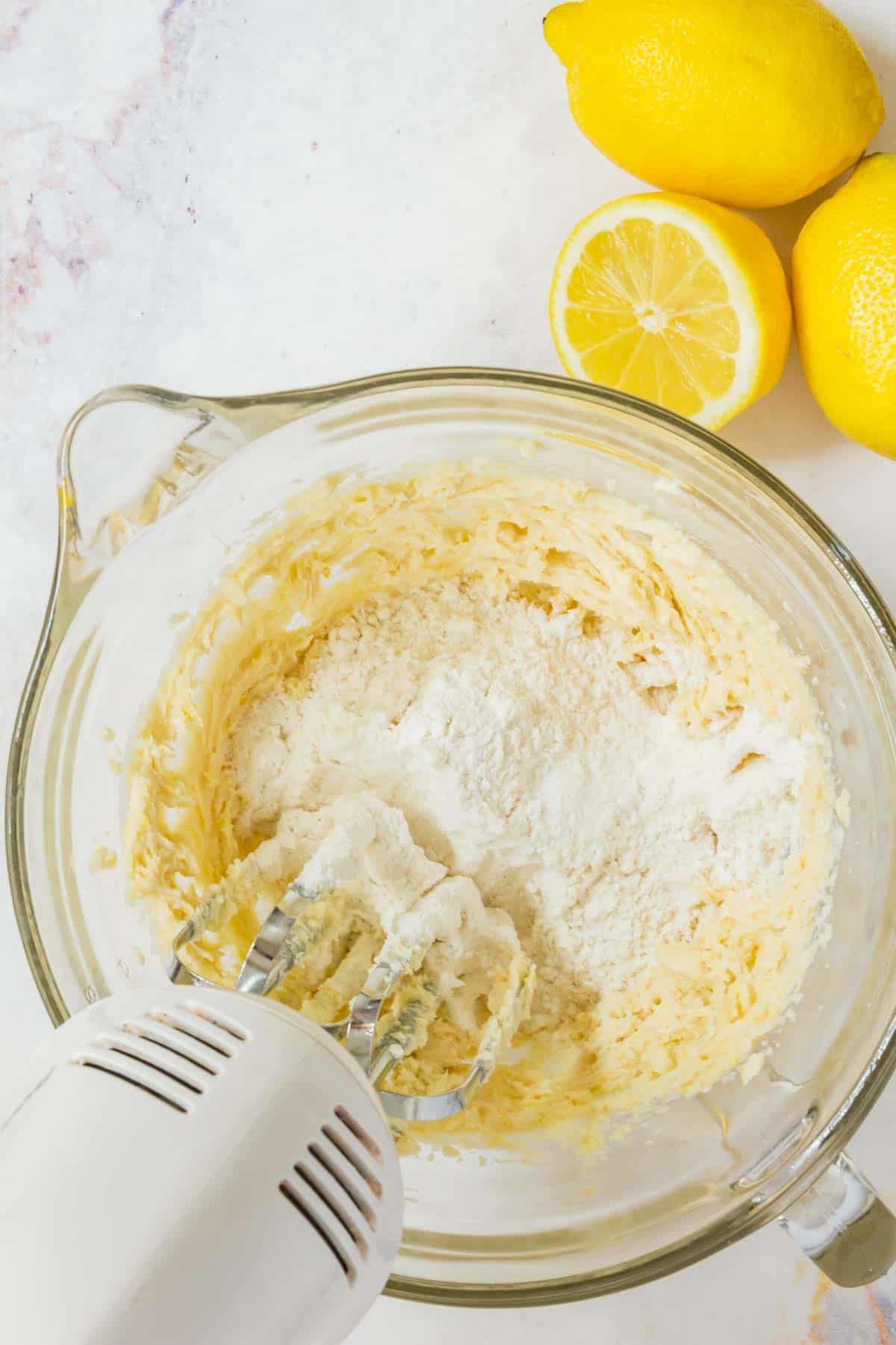 The crust ingredients are beat together with a mixer in a mixing bowl.