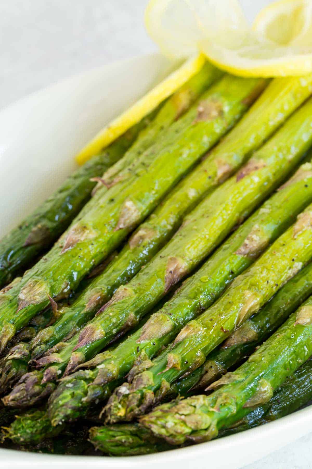 Closeup of the tips of baked asparagus spears.