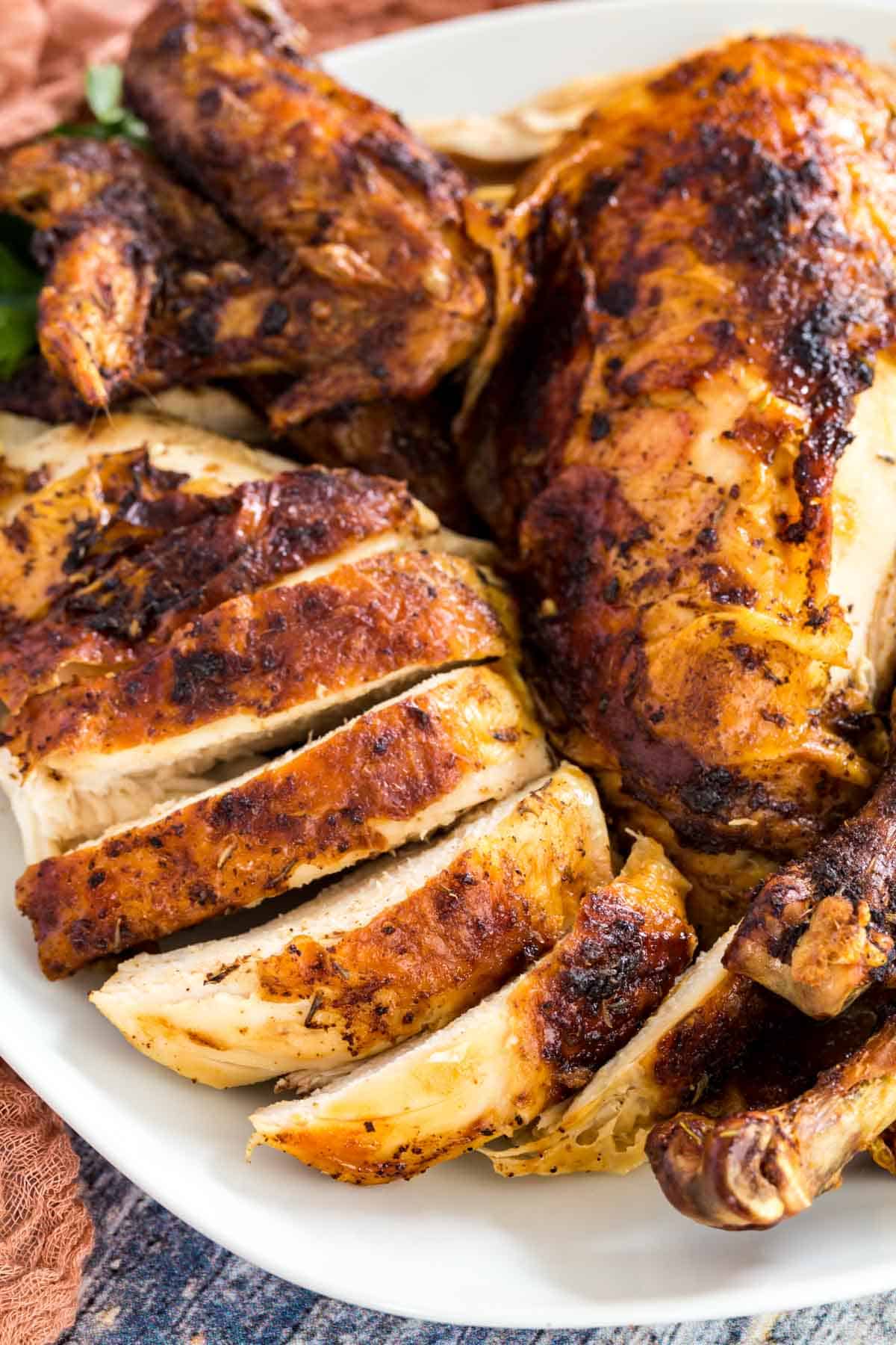 Close up of carved rotisserie chicken breasts and wings.