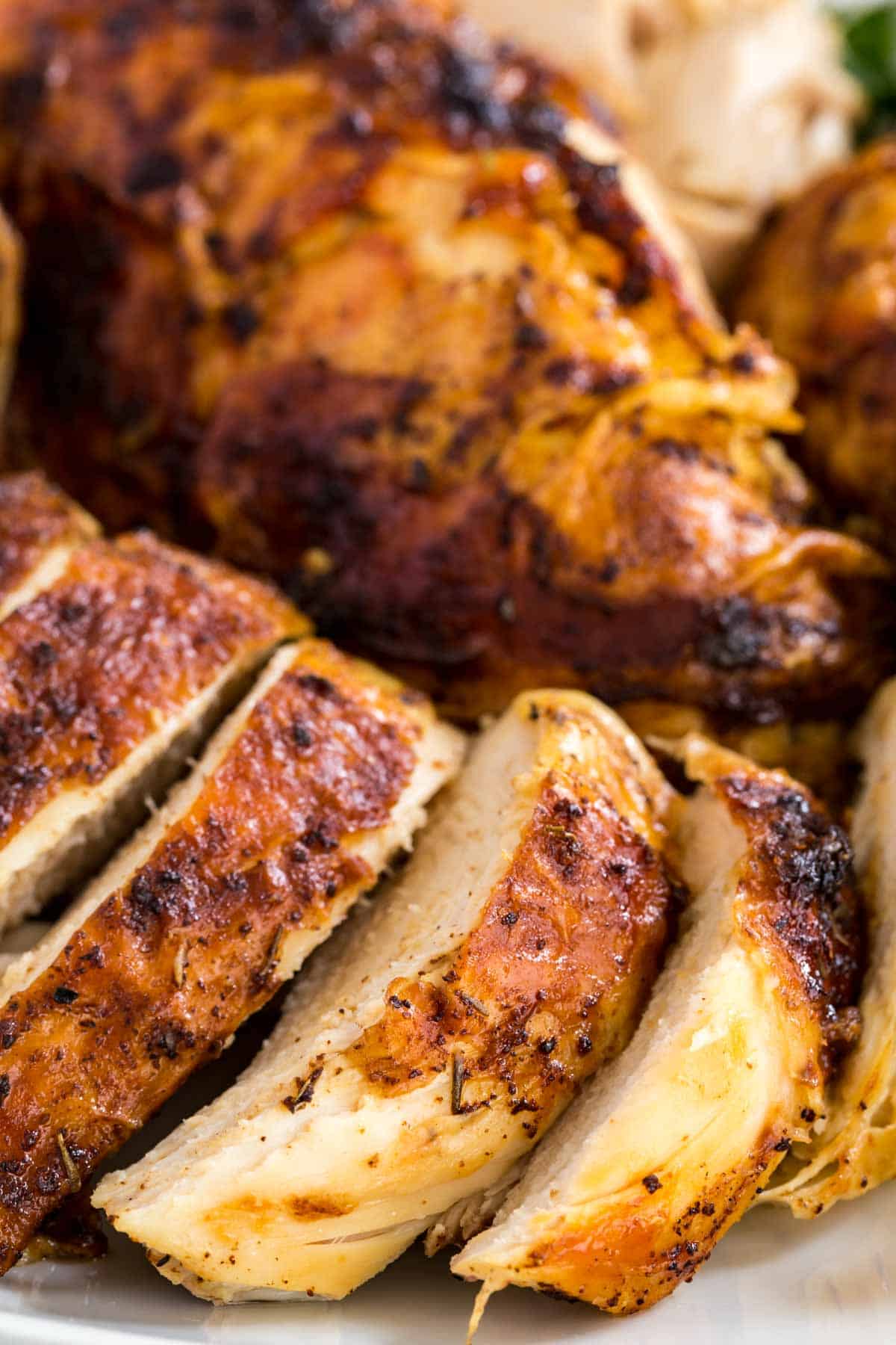 Close up of carved rotisserie chicken breasts.